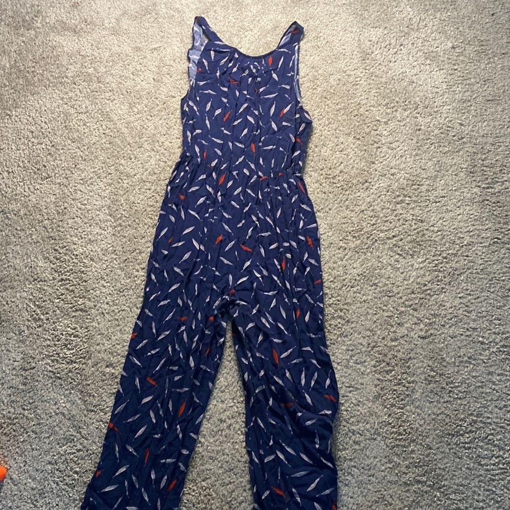 Blue one piece jump suit with white and red feathers from Macy’s. Size Large